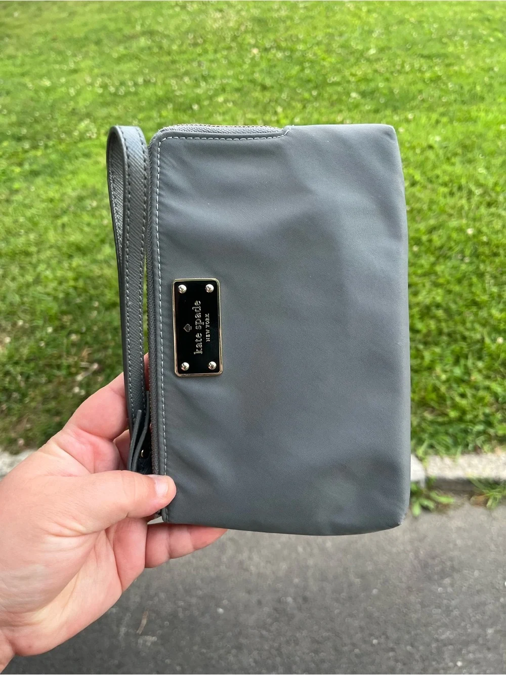 kate spade gray wristlet clutch with gold nameplate